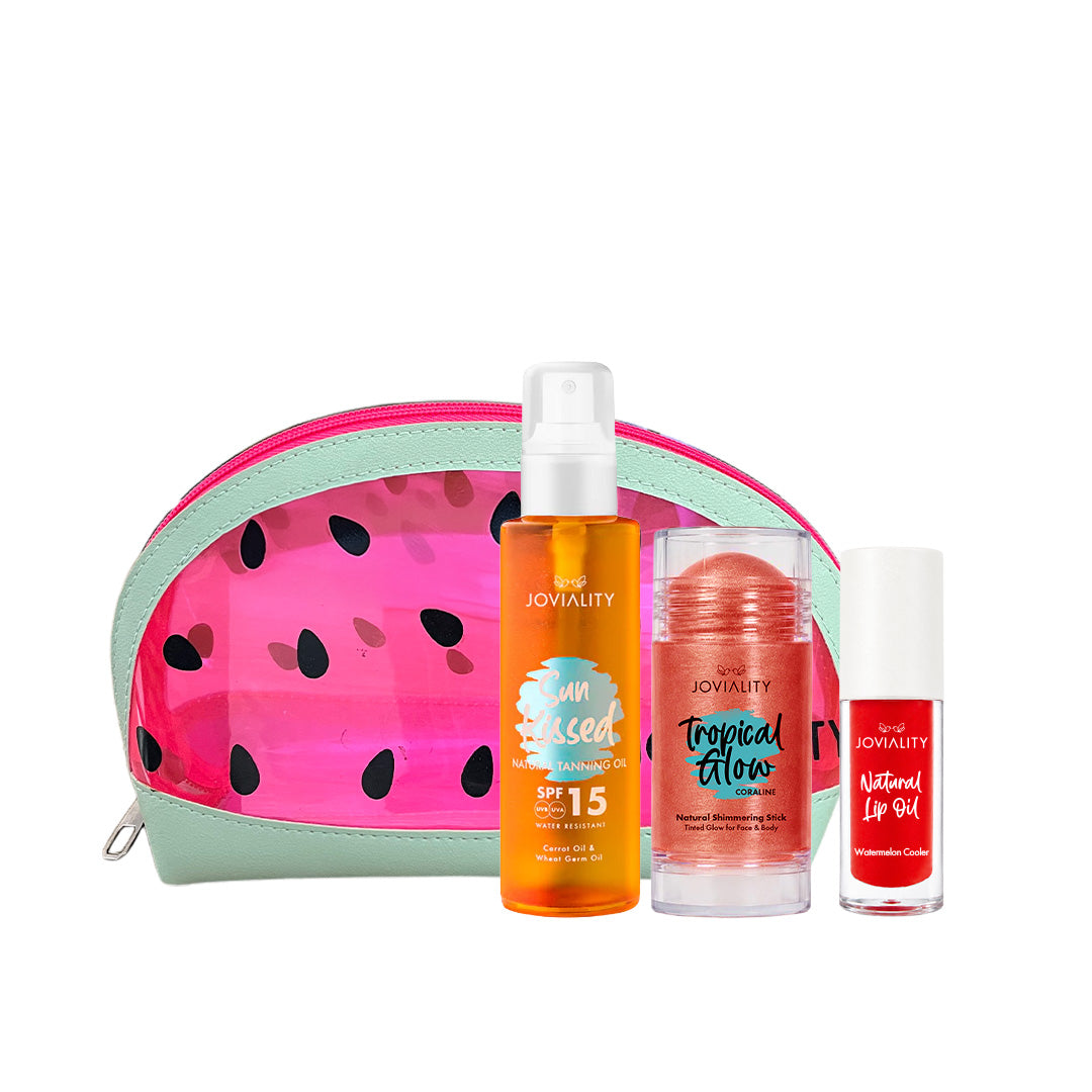 A Joviality self-care summer gift set featuring a watermelon-patterned zippered pouch, an sunkissed tanning dry oil orange body spray bottle, a coral tropical glow balm stick, and a red natural lip oil watermelon flavor, arranged on a white background.